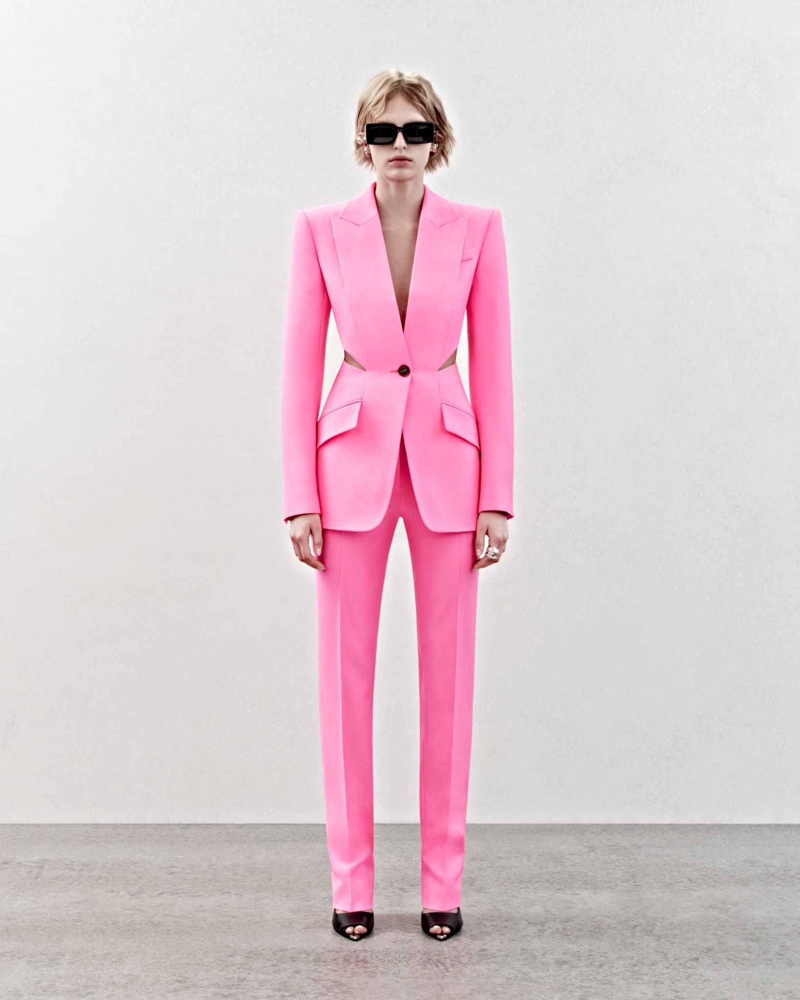 The #McQueenPreAW23 psychedelic pink single-breasted tailored