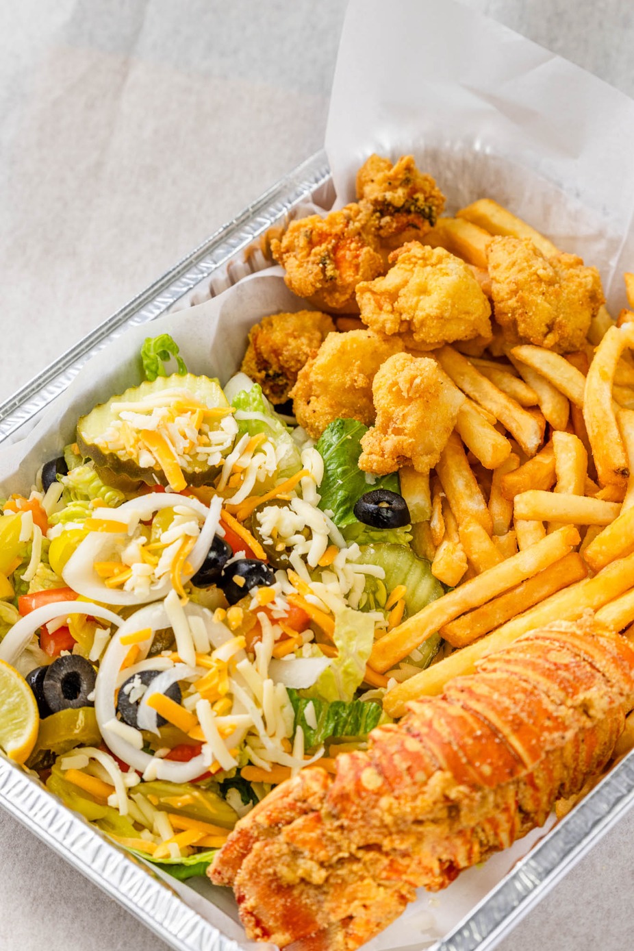 Snappers - Experience a delightful seafood assortment with crispy fries ...