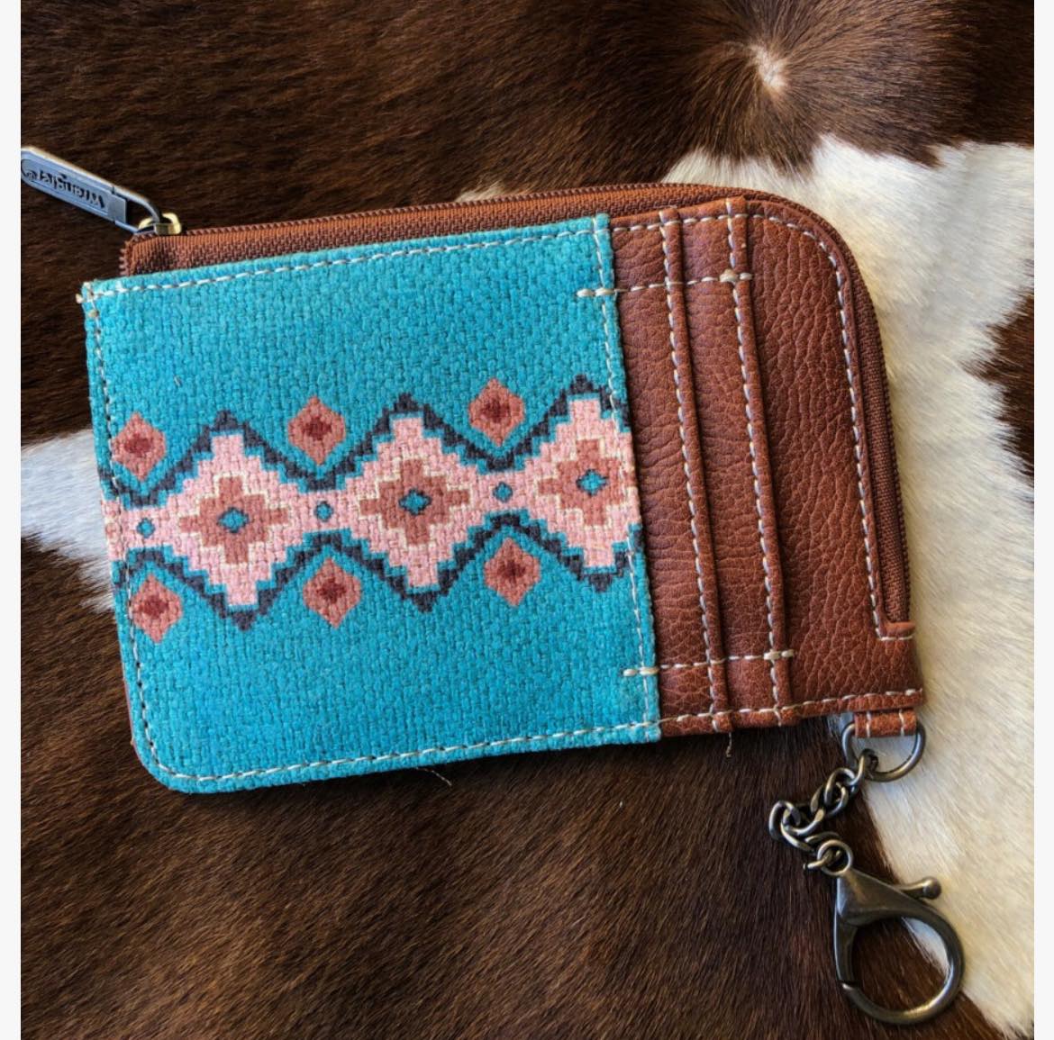 Lost white and tan leopard wallet with gold zipper near Jackson's
