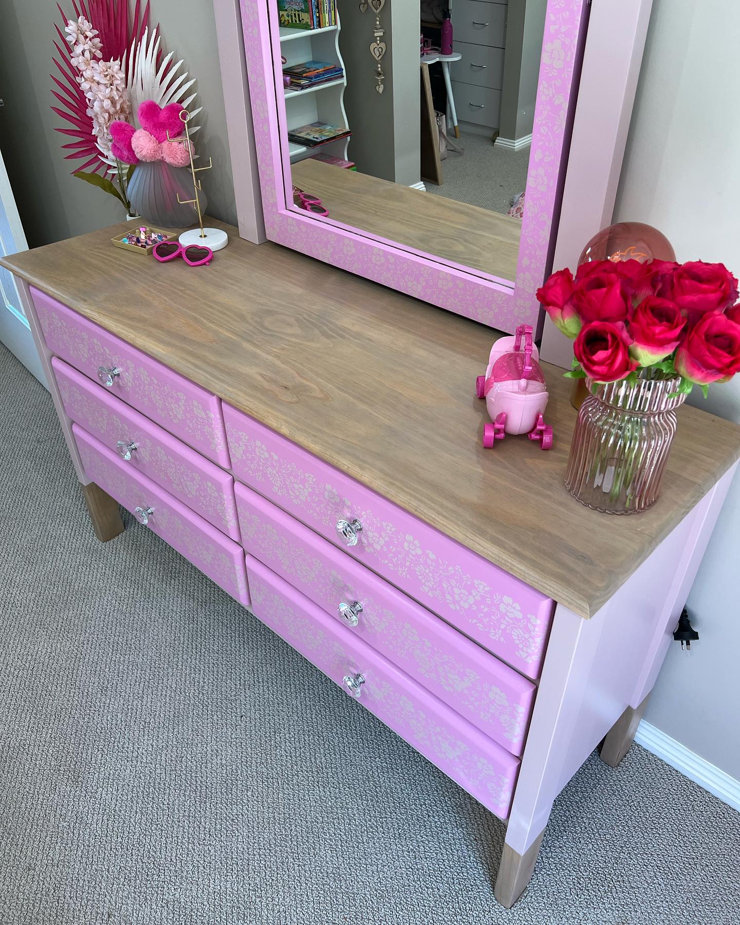 Whimsical Barbie-inspired dresser with gold glitter and floral decor