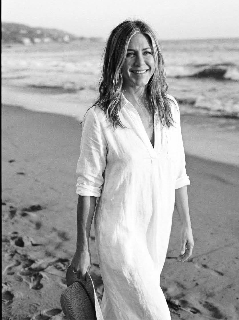 Jennifer Aniston effortlessly commands the spotlight in this breathtaking shot, proving that true style knows no boundaries—not even the open sea. Lounging with unparalleled poise, she brings a high-f