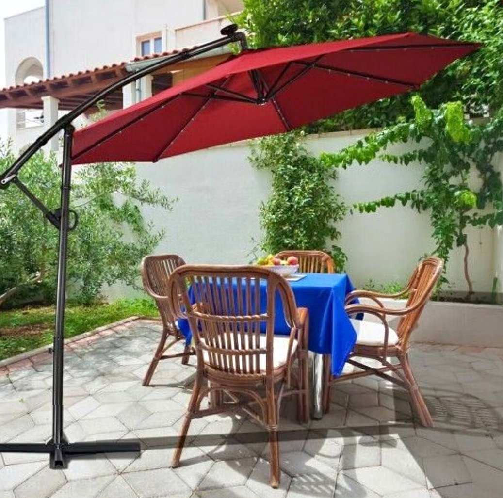 buy used patio umbrella 10 / 11 ft Offset Umbrellas This stylish and practical outdoor umbrella is perfect for family gatherings Market Umbrella Four Seasons Courtyard