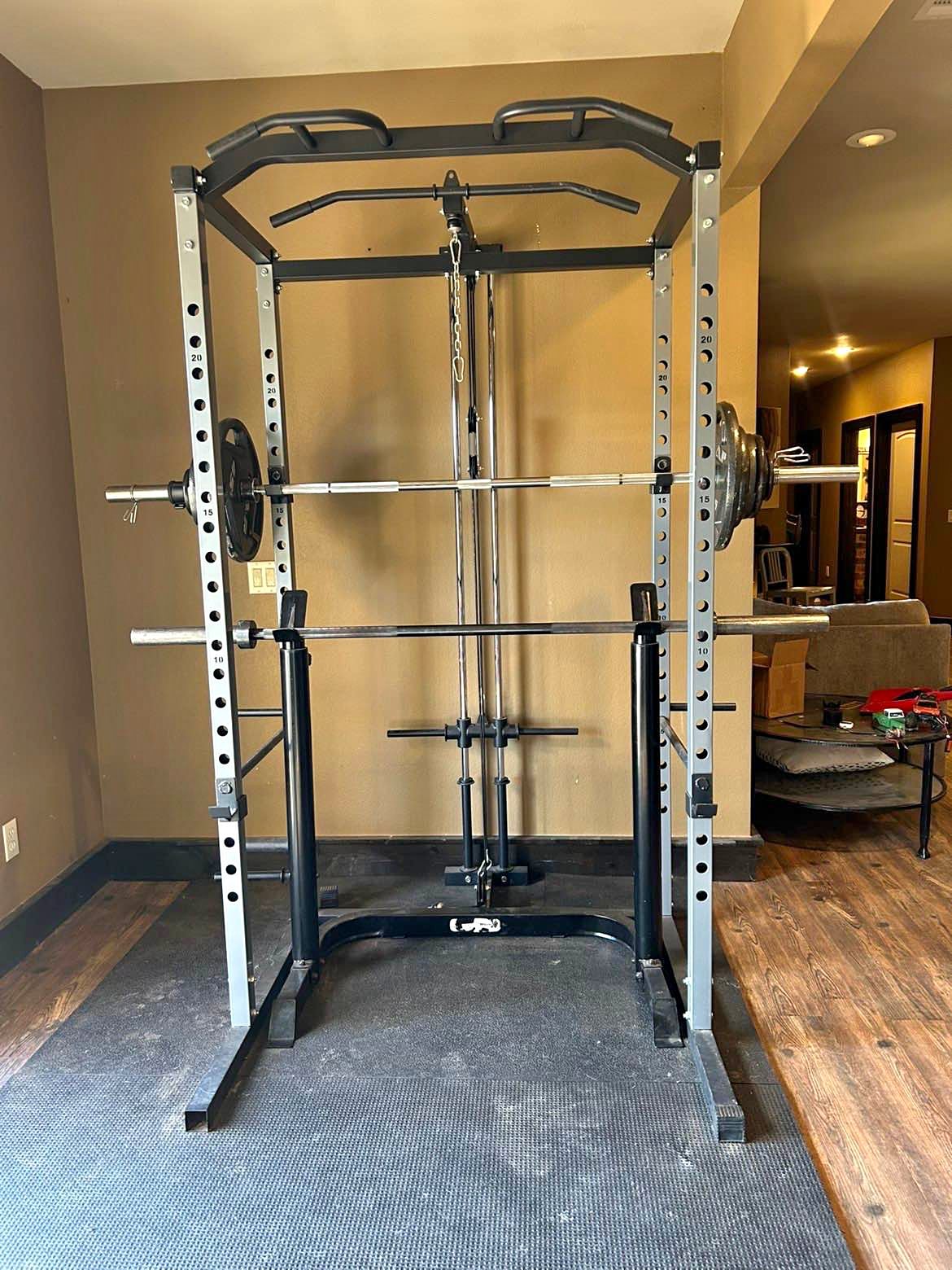 Workout rack with 2 45’s, 25’s, 10’s, and 2.5’s. Workout bench ...