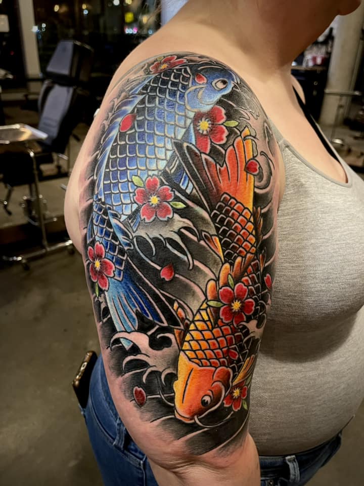 What tattoo designs complement a Japanese half sleeve?