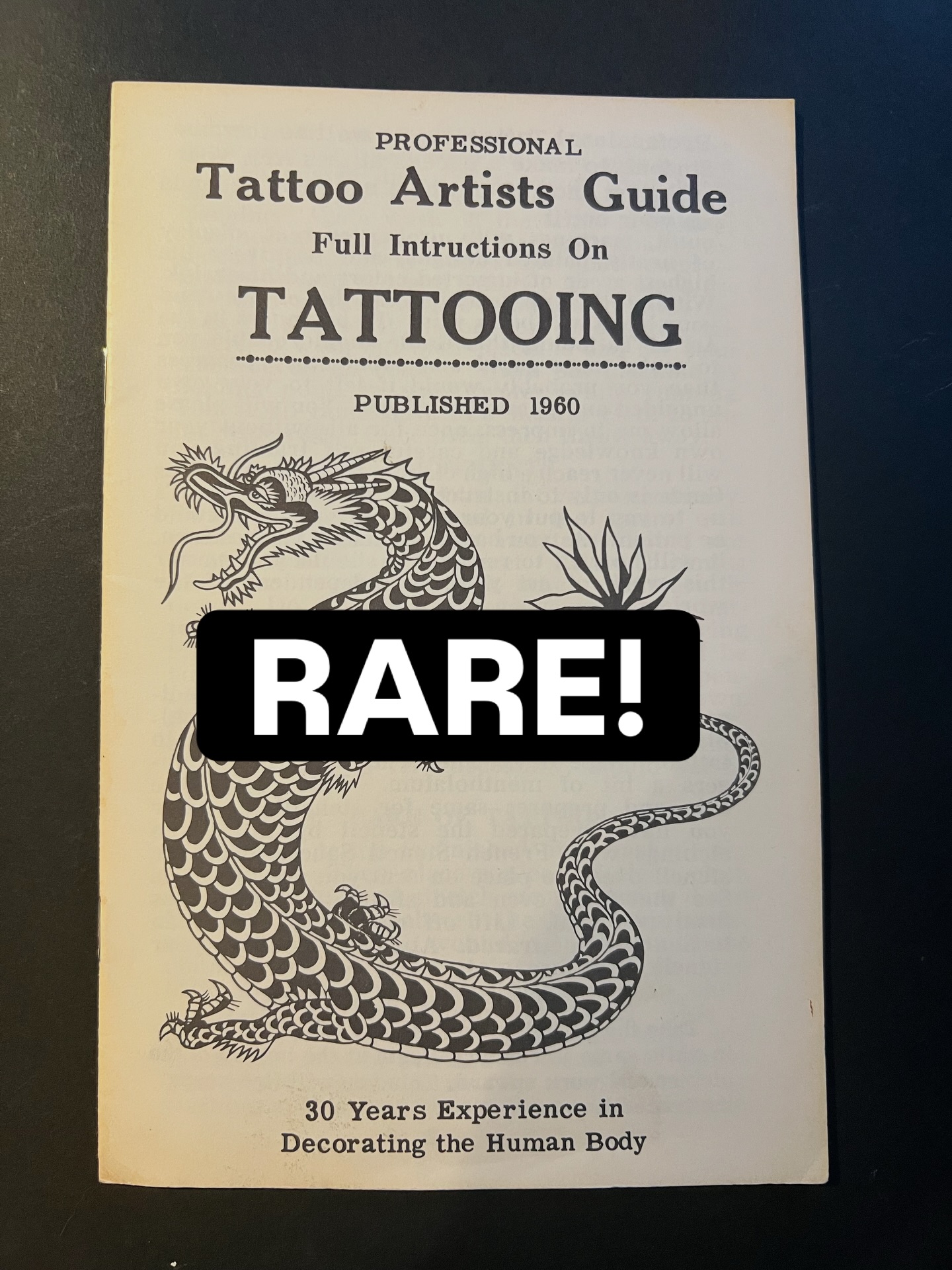 Milton Zeis showing off an issue of Tattooing the World Over first