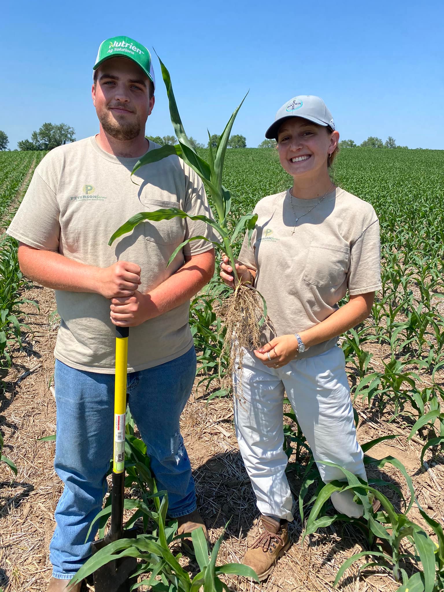 Peterson - Interns Eli and Margarita showing off the roots of a corn ...