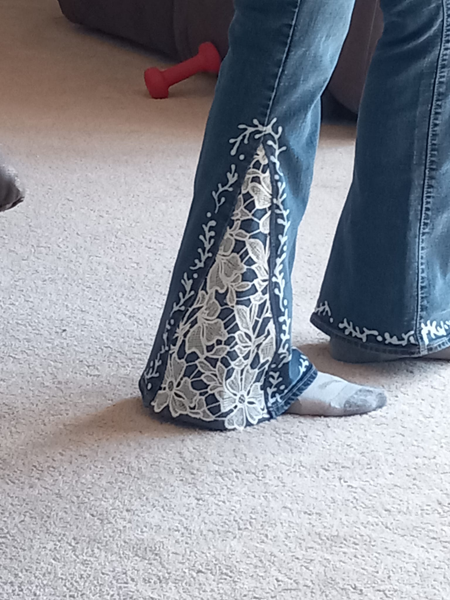 Upcycled jeans with lace flare insert