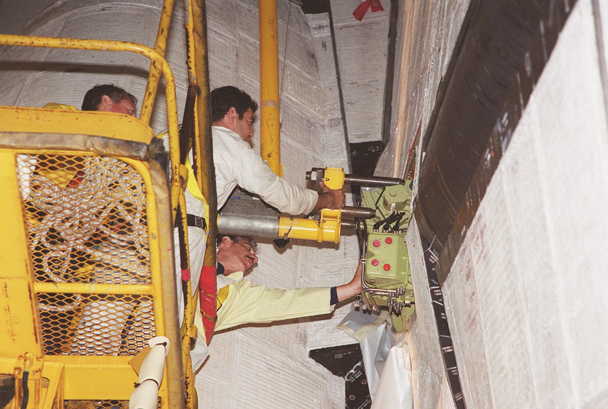 Blast - At Launch Pad 39A, workers move the replacement Power Drive ...