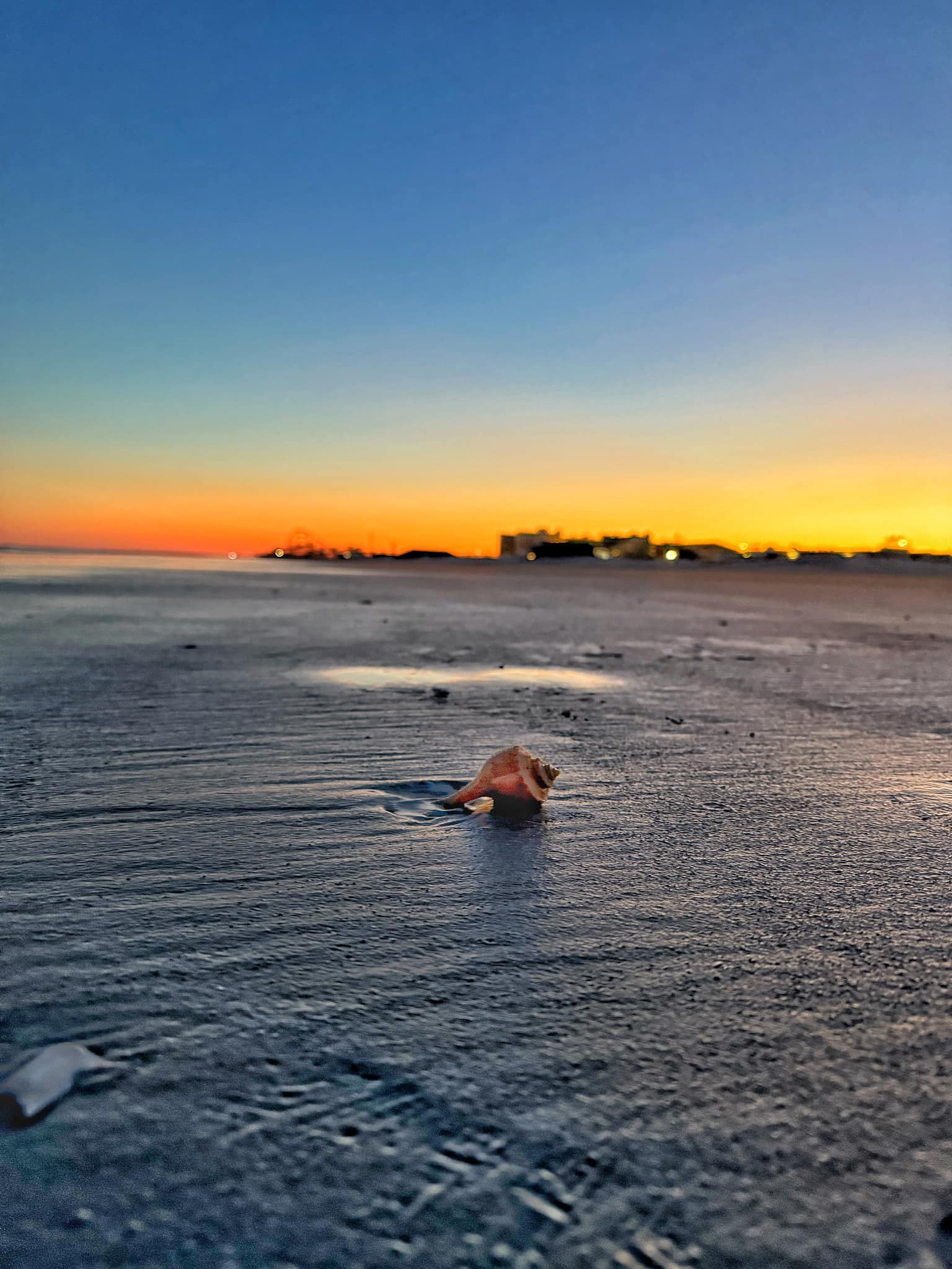 Man spotted beyond the water at Wildwood beach sunset