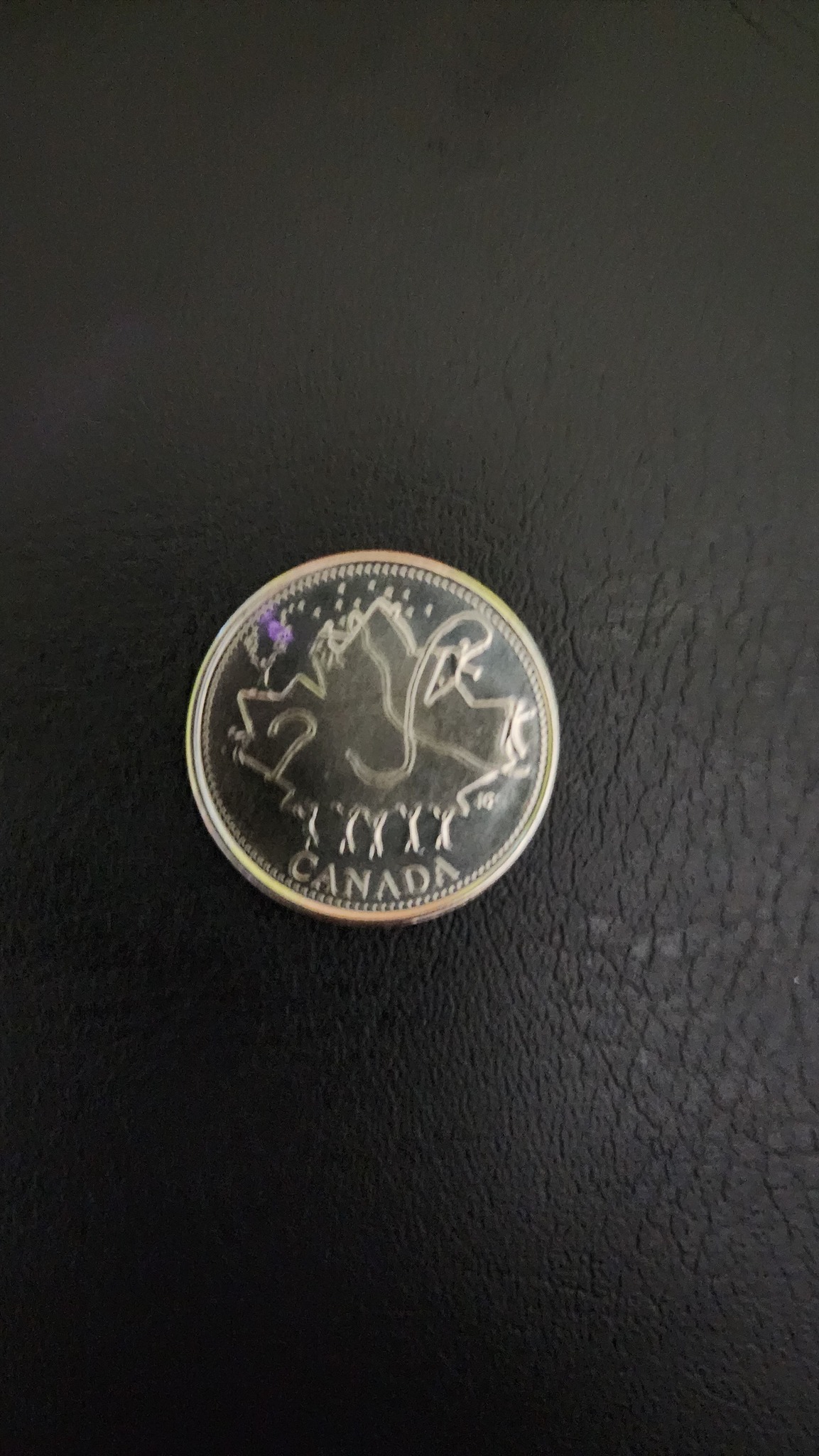 What is the significance of the 1952 and 2002 dates on the coin?