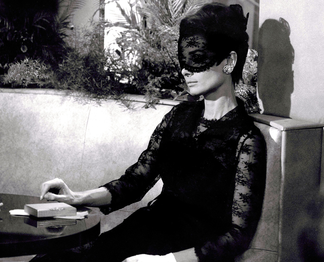 audrey hepburn black lace dress Here is **Audrey Hepburn** in the famous **Givenchy** mask (which coordinates with her black lace dress). He designed the ensemble for 