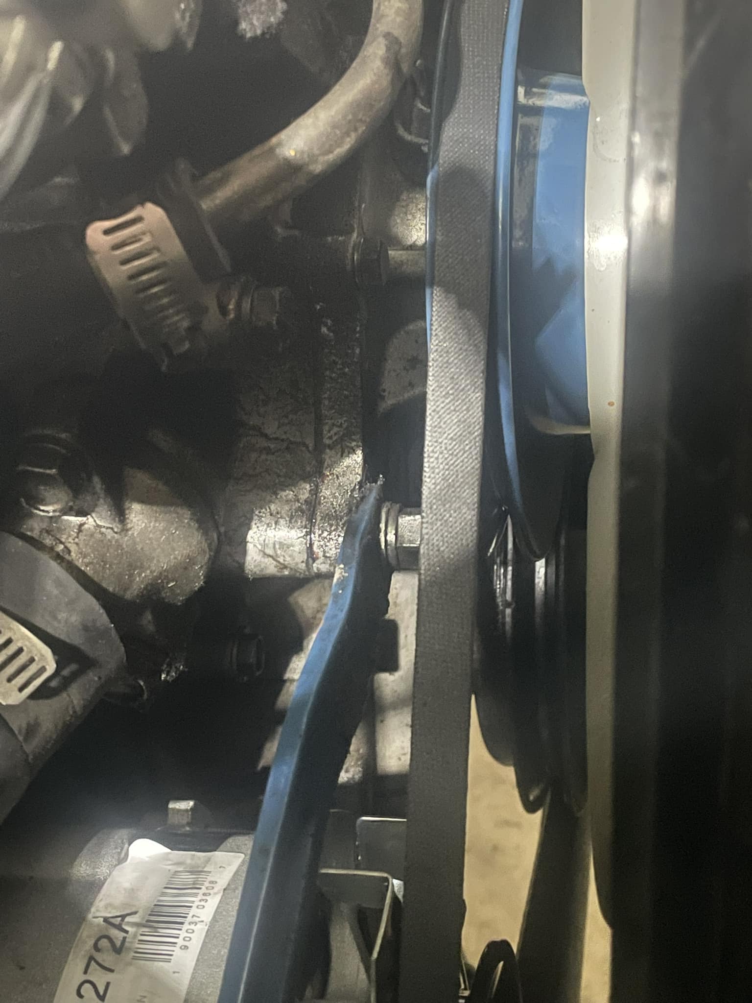 Where should the alternator adjustment bracket be attached on a