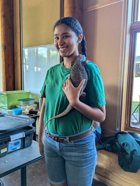 NYS - An exhibitor holding a lizard during the live reptile exhibit ...