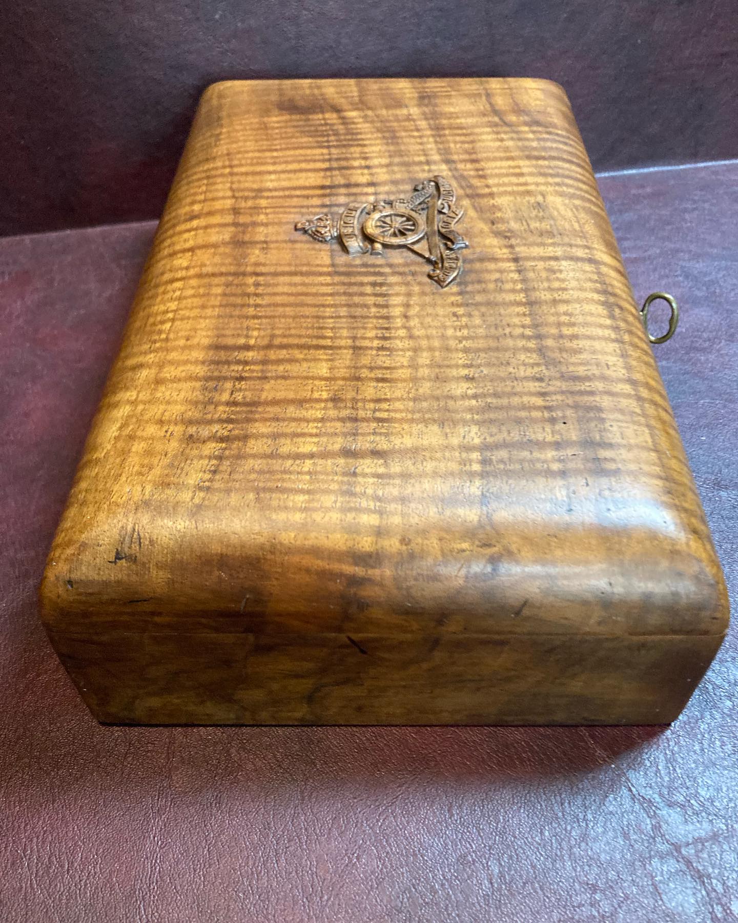 Vintage wooden cigar box is brown with a hinged lid and metal