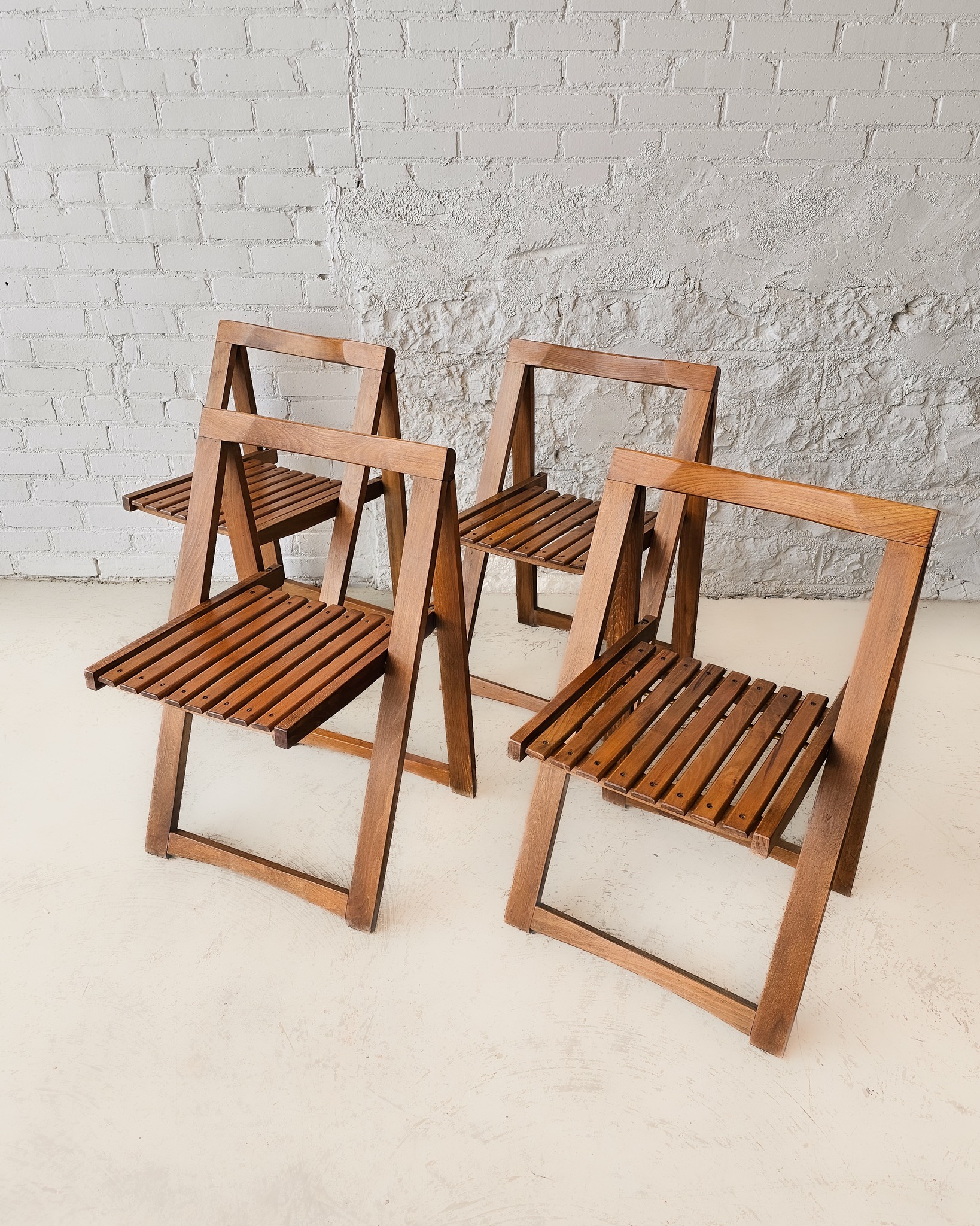 Crafted in the 1960s. these versatile Trieste slatted folding