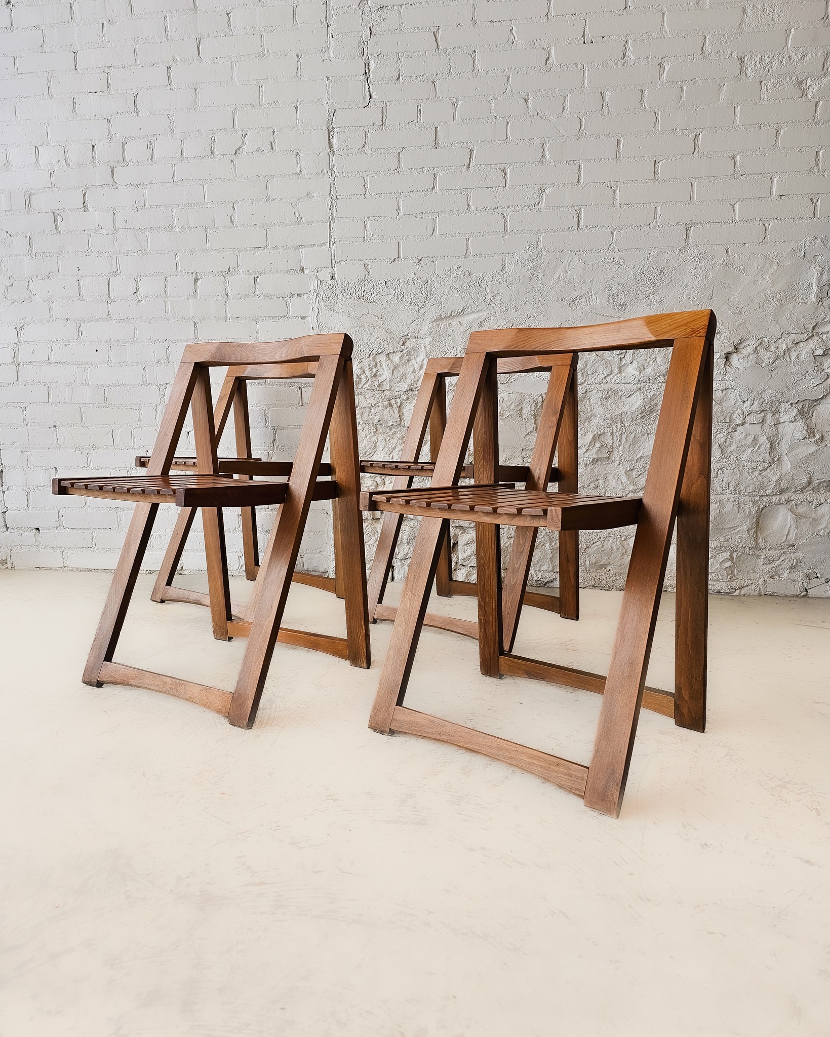 Crafted in the 1960s. these versatile Trieste slatted folding