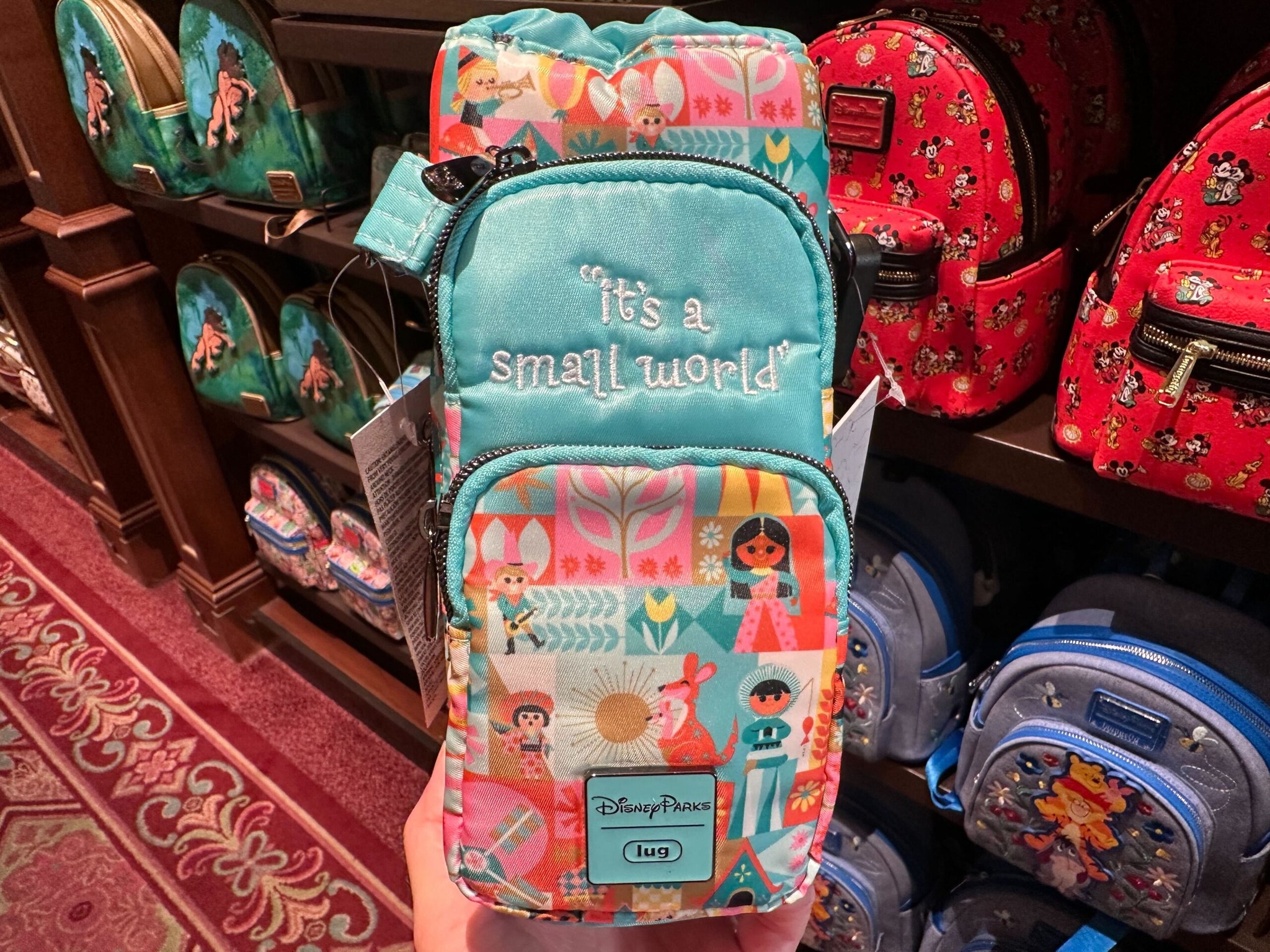 disney it's a small world mini backpack by loungefly The Minnie Mouse Classic Series Backpack: Emerald Iridescent The front pocket features an applique of Mickey Mouse Disney Lug - Volley Mini