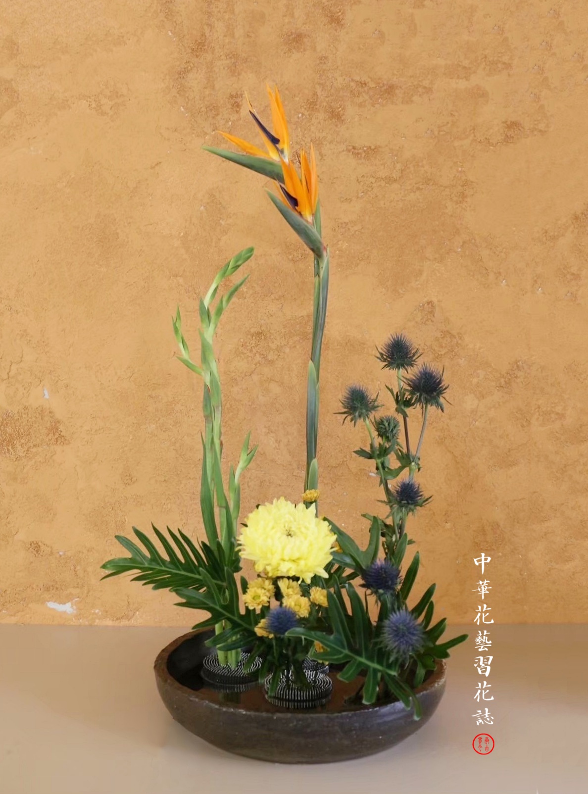 陶盤中，取四立足點成四點成「Z」之造型，常應用在插作水生植物，可作
