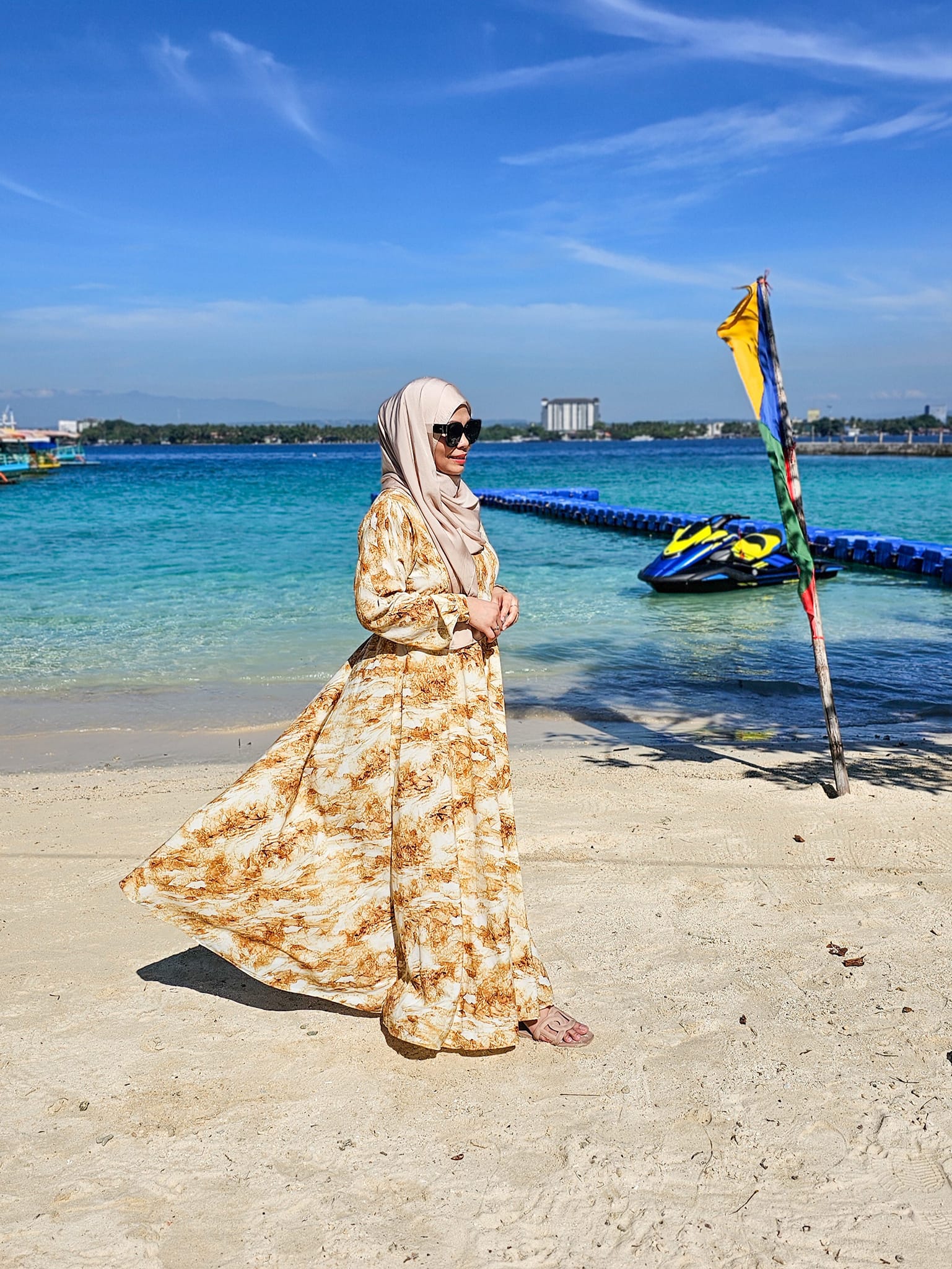 Hijabi girl in luxury resort wear by the ocean
