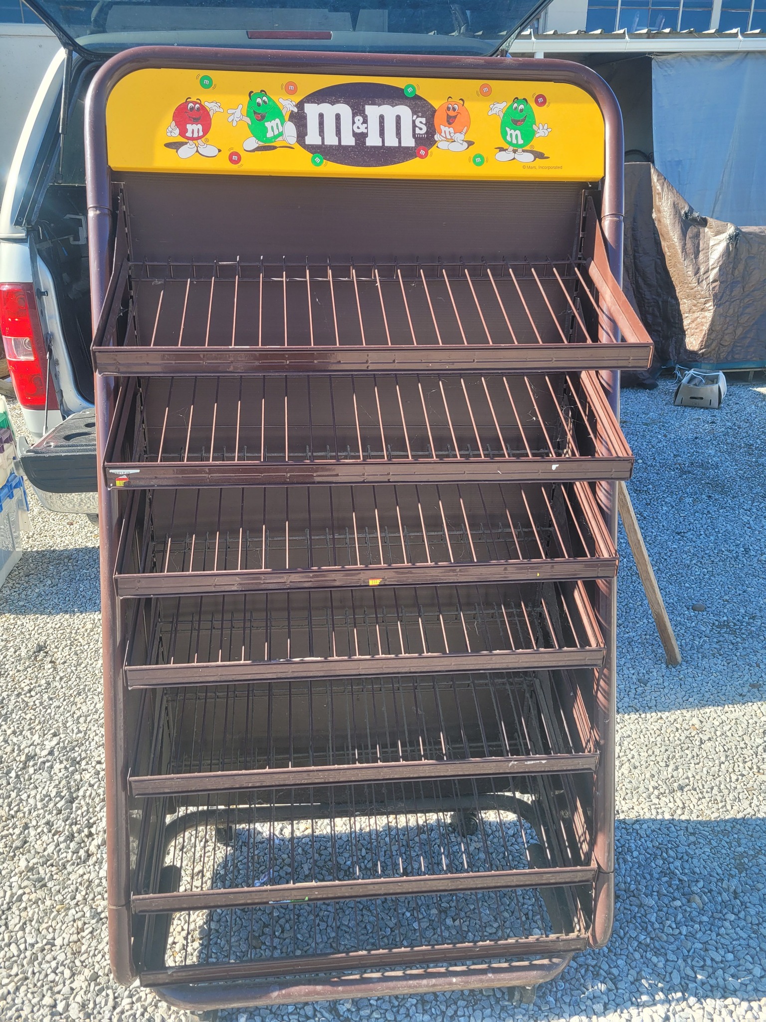 Vintage metal store display rack with header sign