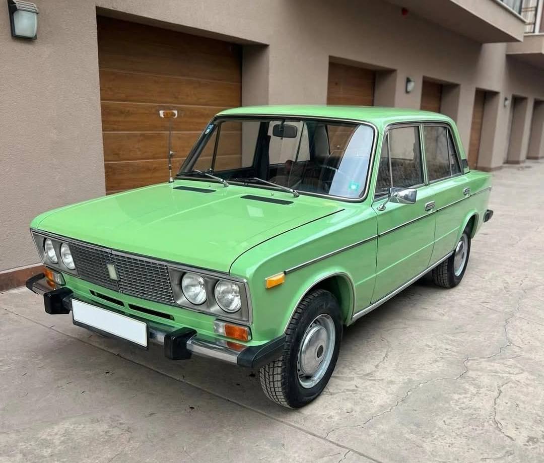 Lada Vaz in a green classic vintage car