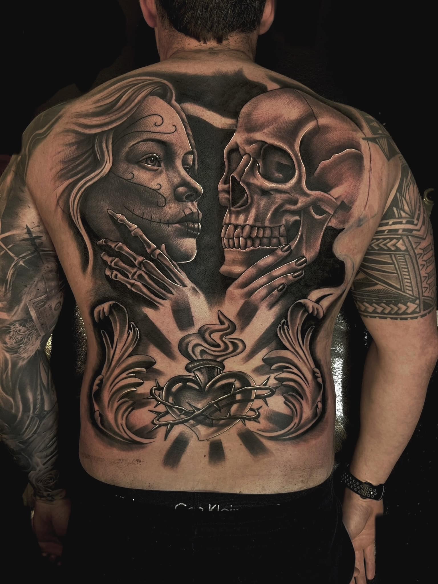Tattoo artist completes back and front piece