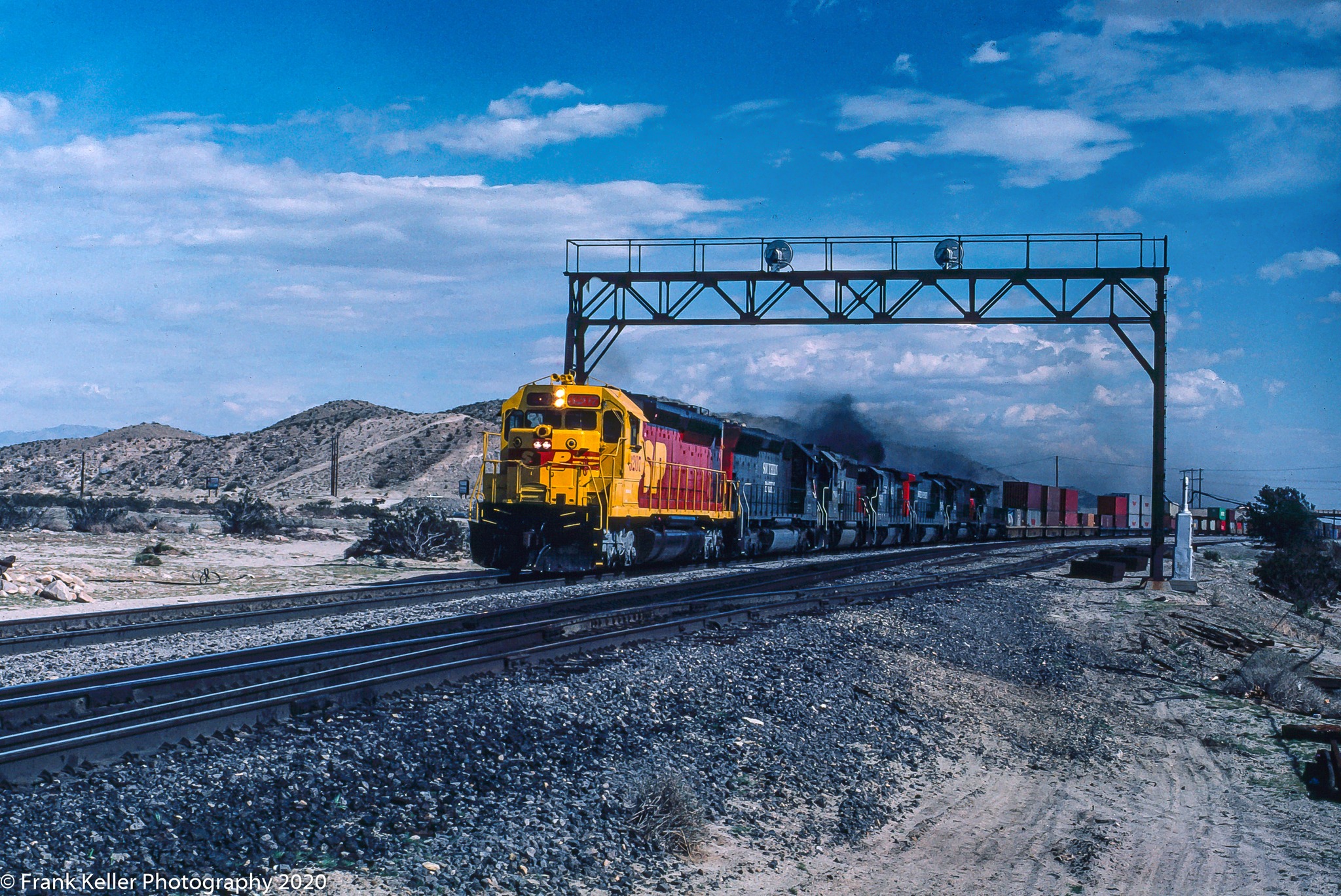 SP 3207 leads the CHEXT through the signal bridge at Garnett on