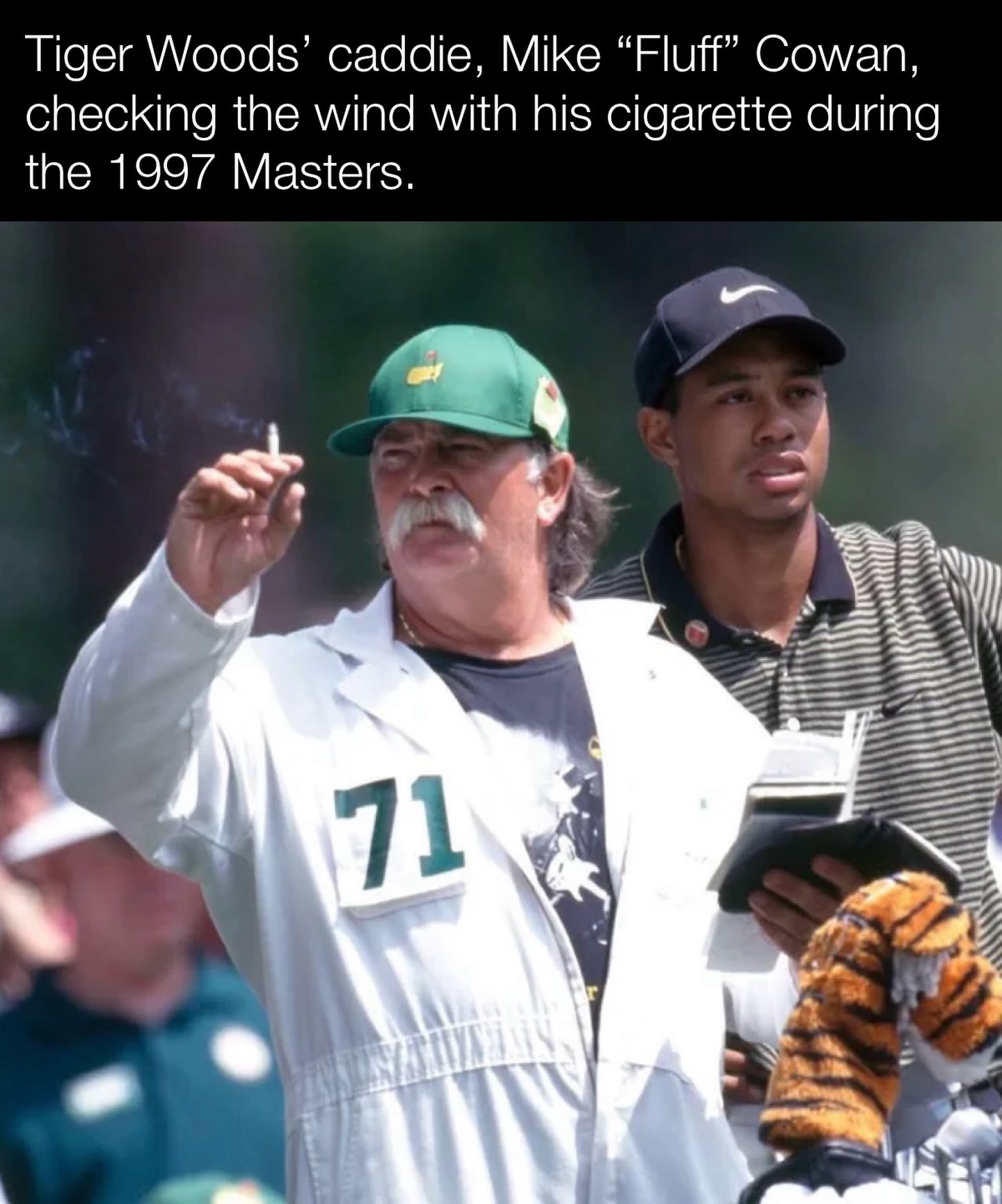 Tiger Woods' caddie, Mike “Fluff” Cowan, checking the wind with his  cigarette during the 1997 Masters