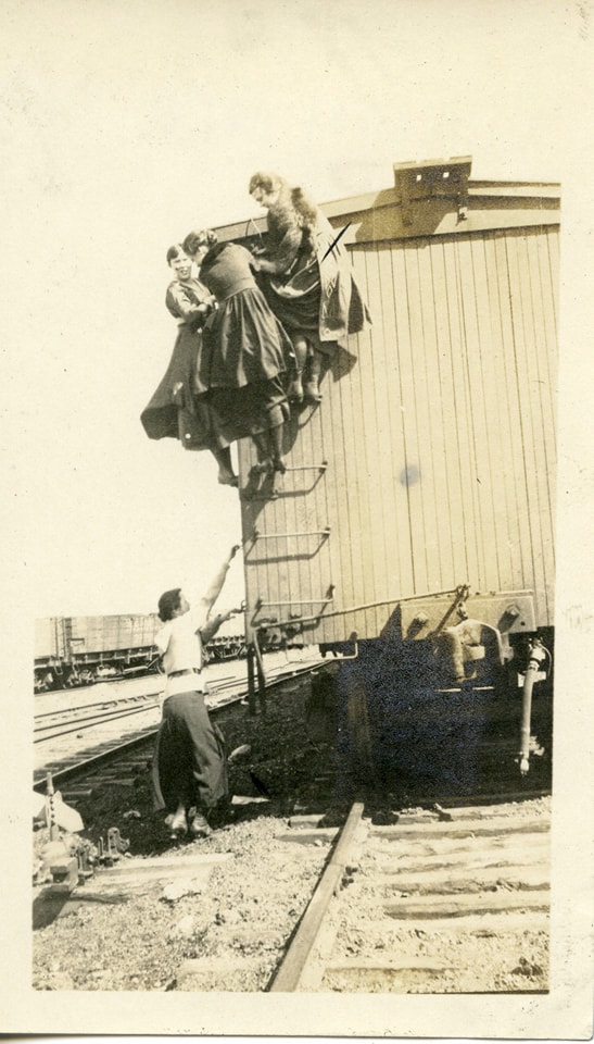 History of the Heartland - Four young ladies grapple with a wooden ...