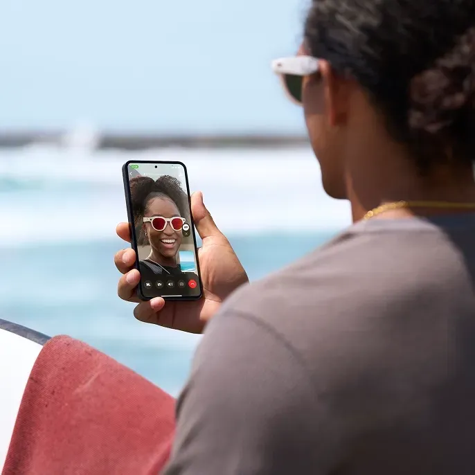 Chatting on phone with both people wearing Oakley HSTN