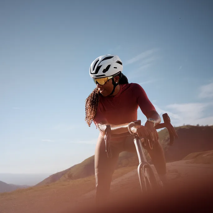 Cyclist with helmet wearing Oakley Meta Vanguard looking off to the side