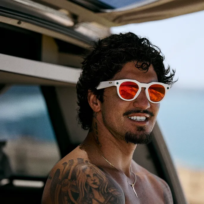 Man smiling looking at the distance wearing Oakley HSTN