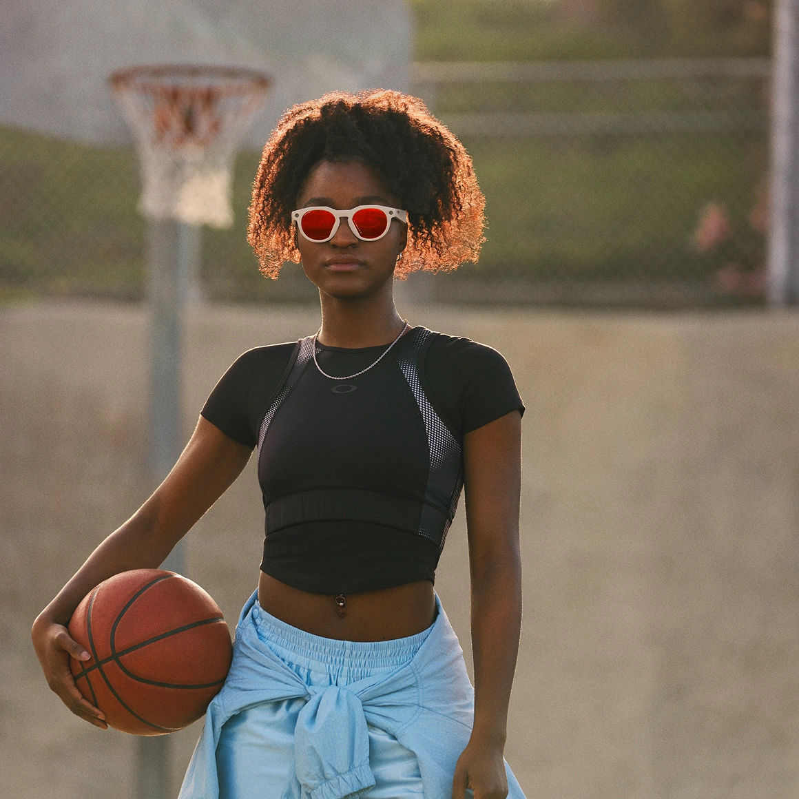 A person modeling the Oakley Meta HSTN AI glasses