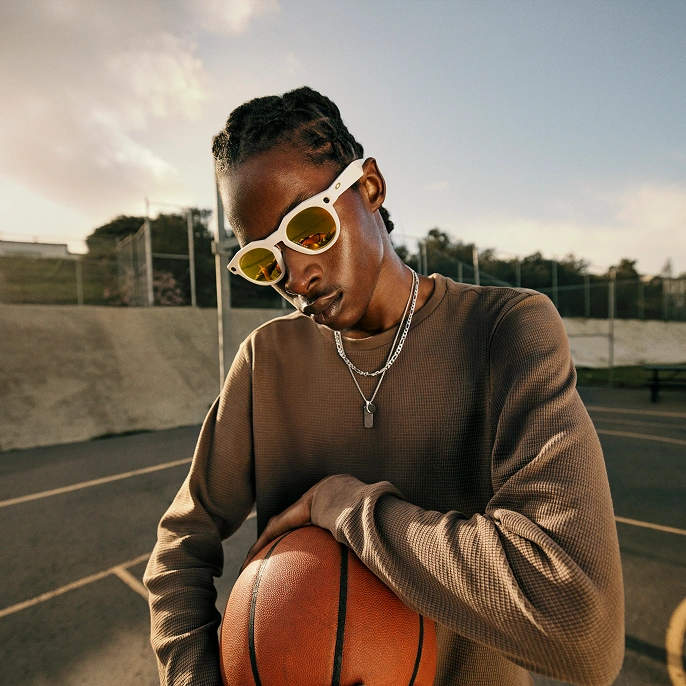 A person modeling the Oakley Meta HSTN AI glasses