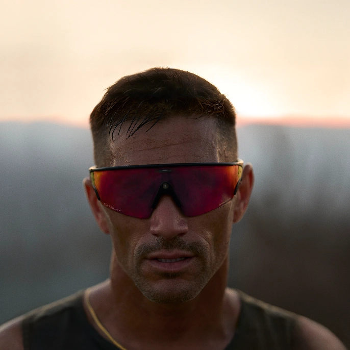 A man wearing Oakley Meta Vanguard glasses with Prizm Road lens.