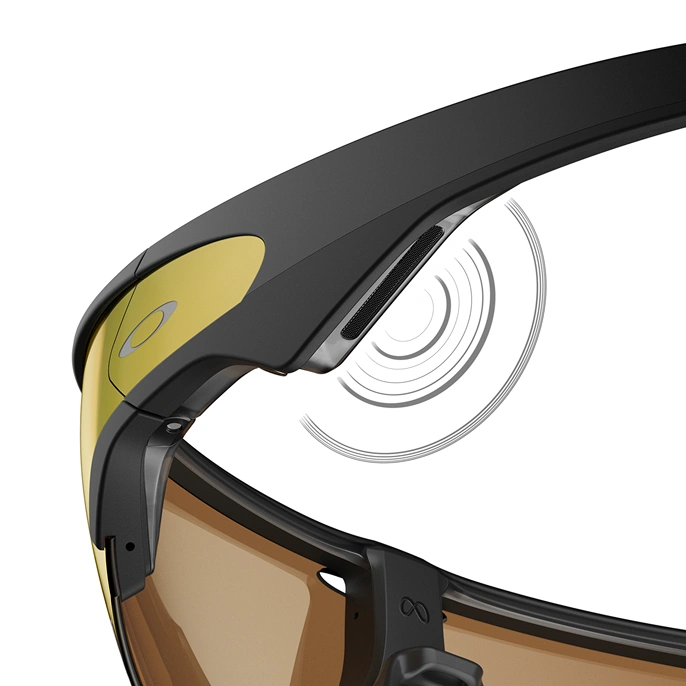 Close up of the Oakley Meta AI glasses’ open-ear speaker, a thin oblong bar with stylized soundwaves radiating outward.